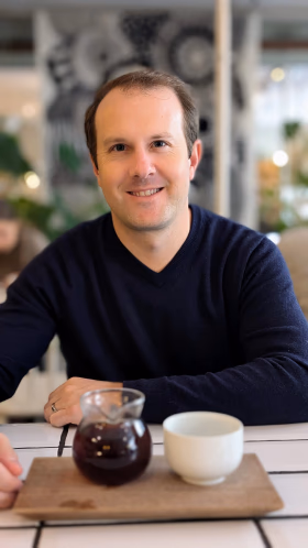 Tyler Vawser, CMO at FoxDen Capital, seated at a cafe in Helsinki, Finland