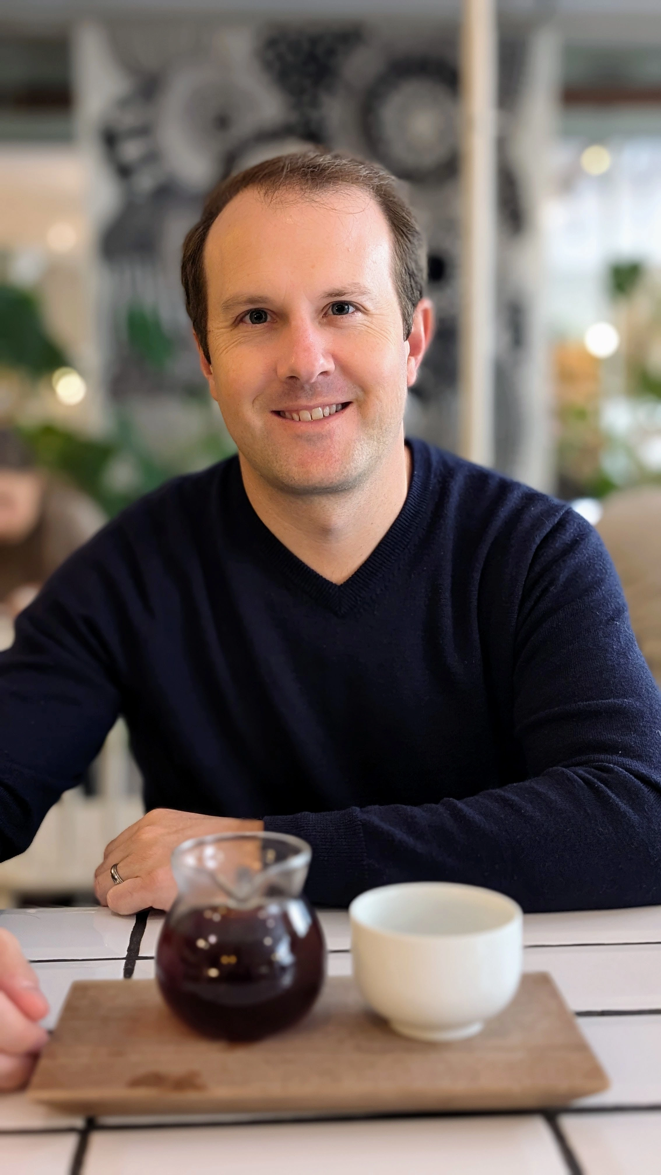 Tyler Vawser, CMO at FoxDen Capital, seated at a cafe in Helsinki, Finland
